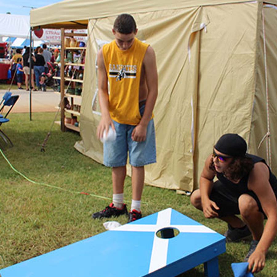 club members playing cornhole